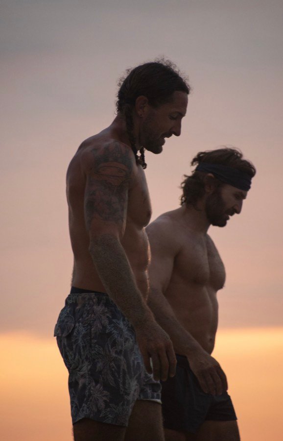 Two players standing together at dusk, a quiet moment after a session.